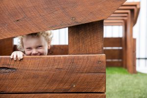 a cute kid in the wooden house of nido child care centre in seven hills