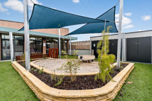 Nido Essendon Terrace with little area covered with green grass, wooden gates and small plants