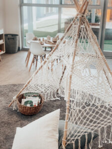 Tent made of wooden sticks and threads placed with pillows and basket